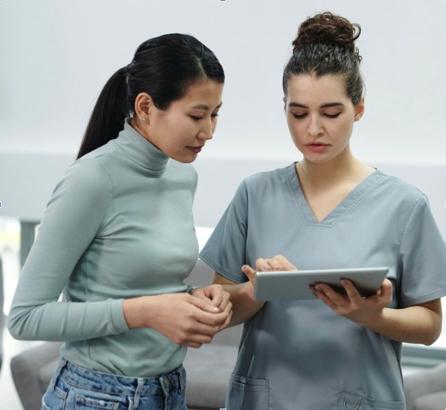 nurse and patient looking at tablet