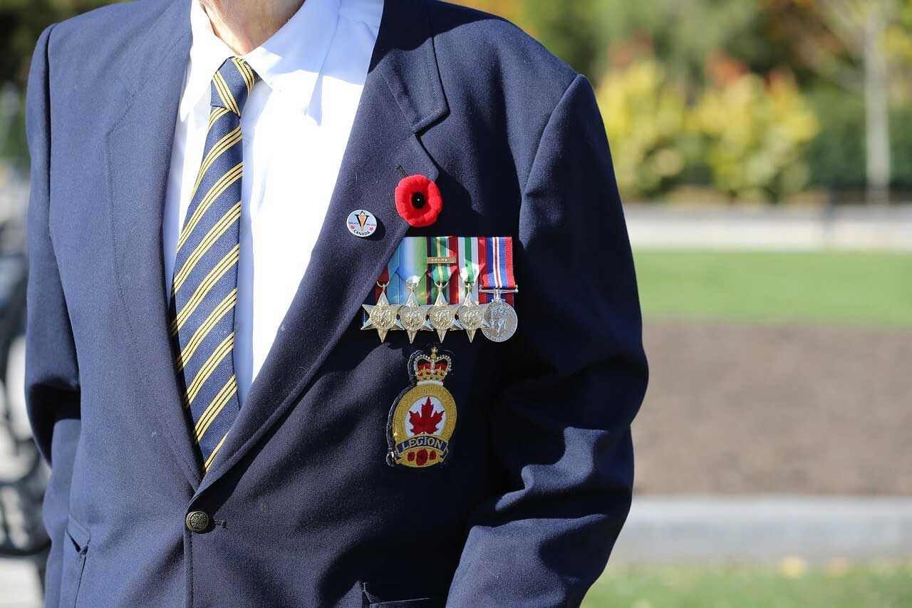 remembrance-day-in-canada anonymous Canadian veteran wearing medals, poppy, and legion badge