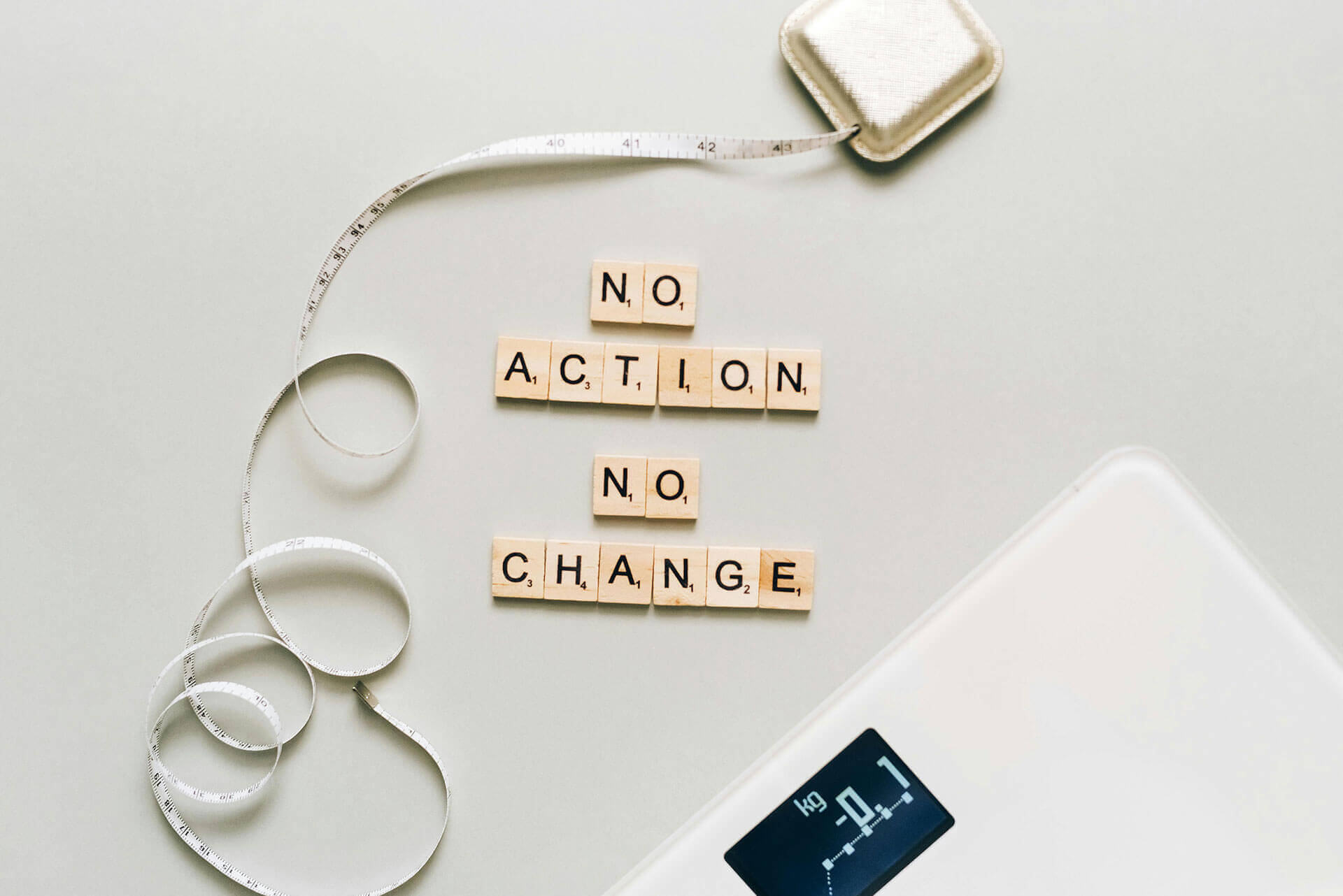 weight loss concept image - measuring tape, scale, and “no action, no change” message